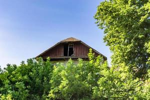 Beautiful old abandoned building farm house in countryside on natural background photo