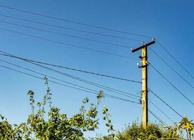 Power electric pole with line wire on colored background close up photo