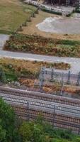 Aerial Footage of Train Tracks Passing Through Luton Town of England. Vertical and Portrait Style Video Clip Was Captured with Drone's Camera