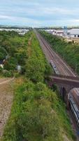 Aerial Footage of Train Tracks Passing Through Luton Town of England. Vertical and Portrait Style Video Clip Was Captured with Drone's Camera