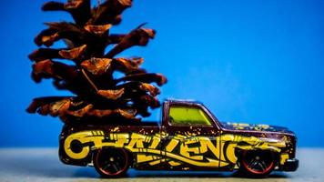 Minahasa, Indonesia  December 2022, the toy car transporting pinecones photo