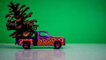 Minahasa, Indonesia  December 2022, the toy car transporting pinecones photo