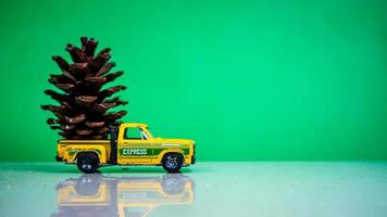 Minahasa, Indonesia  December 2022, the toy car transporting pinecones photo