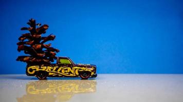 Minahasa, Indonesia  December 2022, the toy car transporting pinecones photo