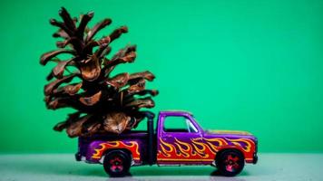 Minahasa, Indonesia  December 2022, the toy car transporting pinecones photo