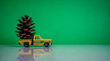 Minahasa, Indonesia  December 2022, the toy car transporting pinecones photo