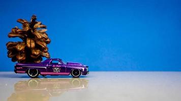 Minahasa, Indonesia  December 2022, the toy car transporting pinecones photo