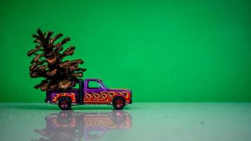 Minahasa, Indonesia  December 2022, the toy car transporting pinecones photo