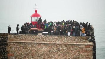 Nazare, Portugal, 2020 - Crowd Enjoy Watching Intense Waves On The Nazare Lighthouse in Portugal - Slow Motion Shot video
