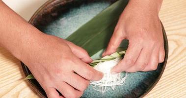 Food Plating - Hands Of A Chef Arranging Thin Slices Of Fresh Cucumber And Shredded Radish In A Plate. - high angle shot video