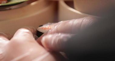 Chef Putting Maki And Salmon Sushi Rolls In Stack. - close up shot video