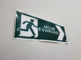 Jalur Evakuasi Evacuation Route sign in green color photo