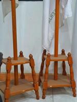 Photo of an indoor flagpole stand made of wood. It has four legs as a solid base so it doesn't fall easily.