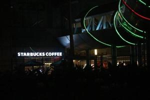 Bekasi, Indonesia in July 2022. Starbucks Cafe logo that glows in the dark. photo