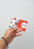 West Java, Indonesia in January 2023. Isolated white photo of a hand holding the KAKOO product brand tag