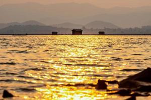 Silhouette fish farming cages in a rural lifestyle photo