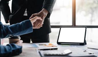 Close up of Business people shaking hands, finishing up meeting, business etiquette, congratulation, merger and acquisition concept photo