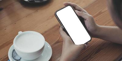 Close up of woman using cell phone,sending massages on the coffee shop.having sunbath.Phone with black screen,texting,video calls, photo