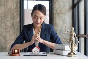 concepto inmobiliario, empresaria sosteniendo un icono de casa. casa en mano. seguro de propiedad y concepto de seguridad. gesto protector de mujer y símbolo de casa. foto