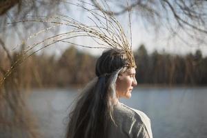 Close up middle age woman with willow branches crown portrait picture photo
