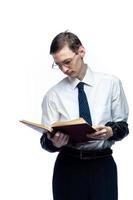 A business man in a tie and glasses with a magazine in his hands on a white, isolated background photo