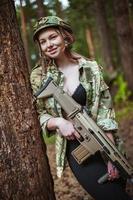 Beautiful portrait of a girl holding a gun photo