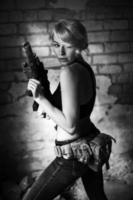 Beautiful portrait of a girl holding a gun photo
