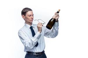 Business man with a bottle of wine in his hands on a white, isolated background photo