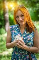 Hedgehog in hand close-up, outdoors photo