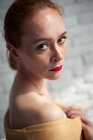 Girl posing against a white wall in her underwear photo