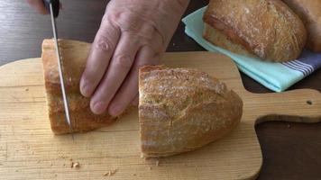 mãos femininas cortando pão caseiro video