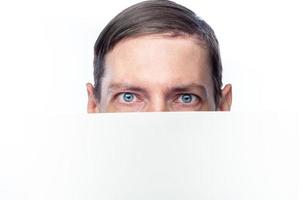 The person's face is covered with a white piece of paper, on an isolated background photo