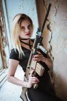 Beautiful portrait of a girl holding a gun photo