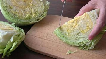 Iceberg lettuce fresh salad leaves.The geometric patterns of the leaves inside the heart of a cut and sliced lettuce Lactuca sativa salad video