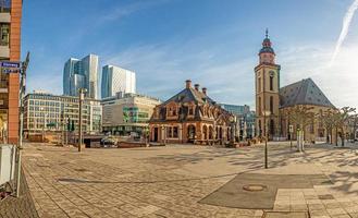 View over the square at the Hauptwache in Frankfurt with St. Catherine's Church and skyscrapers of the skyline in morning light photo