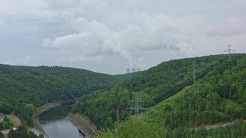 Dalesice Hydro Power Plant on the Jihlava River and in the background the cooling towers of nuclear power plants Dukovany, Trebic District, Czech republic, Europe. video