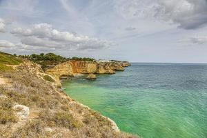 View on typical cliffy beach at Algarve coastline in Portugal in summer photo