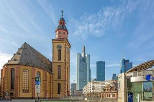 View over the square at the Hauptwache in Frankfurt with St. Catherine's Church and skyscrapers of the skyline in morning light photo