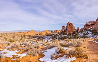 Panoramic picture of natural and geological wonders of Arches national park in Utah in winter photo