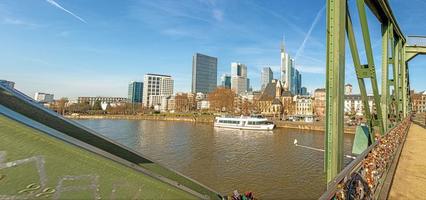 View from the pedestrian bridge Eiserner Steg in Frankfurt over the Main river and the skyline during the day with blue sky photo