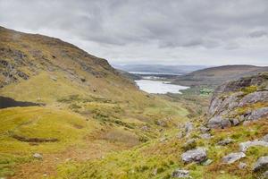 Typical Irish landscape with green meadows and rough mountains during daytime photo