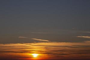 Picture of dramatic and colorful sky with sun during sunset photo