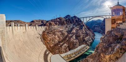 View from Hoover Dam over Colorado river with Mike O Callaghan Pat Tillman Memorial Bridge in the evening photo