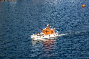 Picture of pilot cutter taken from a cruise ship during daytime photo