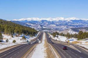 View on highway with Rocky Mountains in the background in winter photo