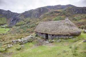 Picture of typical Irish landscape with medieval stone house during daytime photo