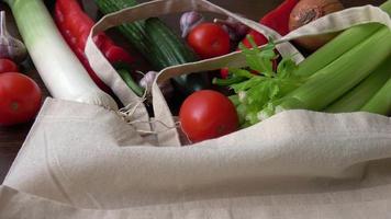 Eco bag with products vegetables.Zero waste use less plastic concept. Fresh vegetables organic in eco cotton fabric bags on wooden table video