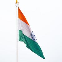 India flag flying high at Connaught Place with pride in blue sky, India flag fluttering, Indian Flag on Independence Day and Republic Day of India, tilt up shot, Waving Indian flag, Har Ghar Tiranga photo