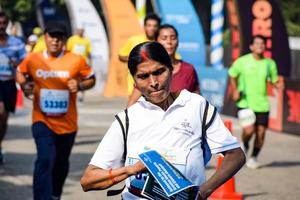 New Delhi, India - October 16 2022 - Vedanta Delhi Half Marathon race after covid in which marathon participants about to cross the finish line, Delhi Half Marathon 2022 photo