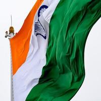 India flag flying high at Connaught Place with pride in blue sky, India flag fluttering, Indian Flag on Independence Day and Republic Day of India, tilt up shot, Waving Indian flag, Har Ghar Tiranga photo